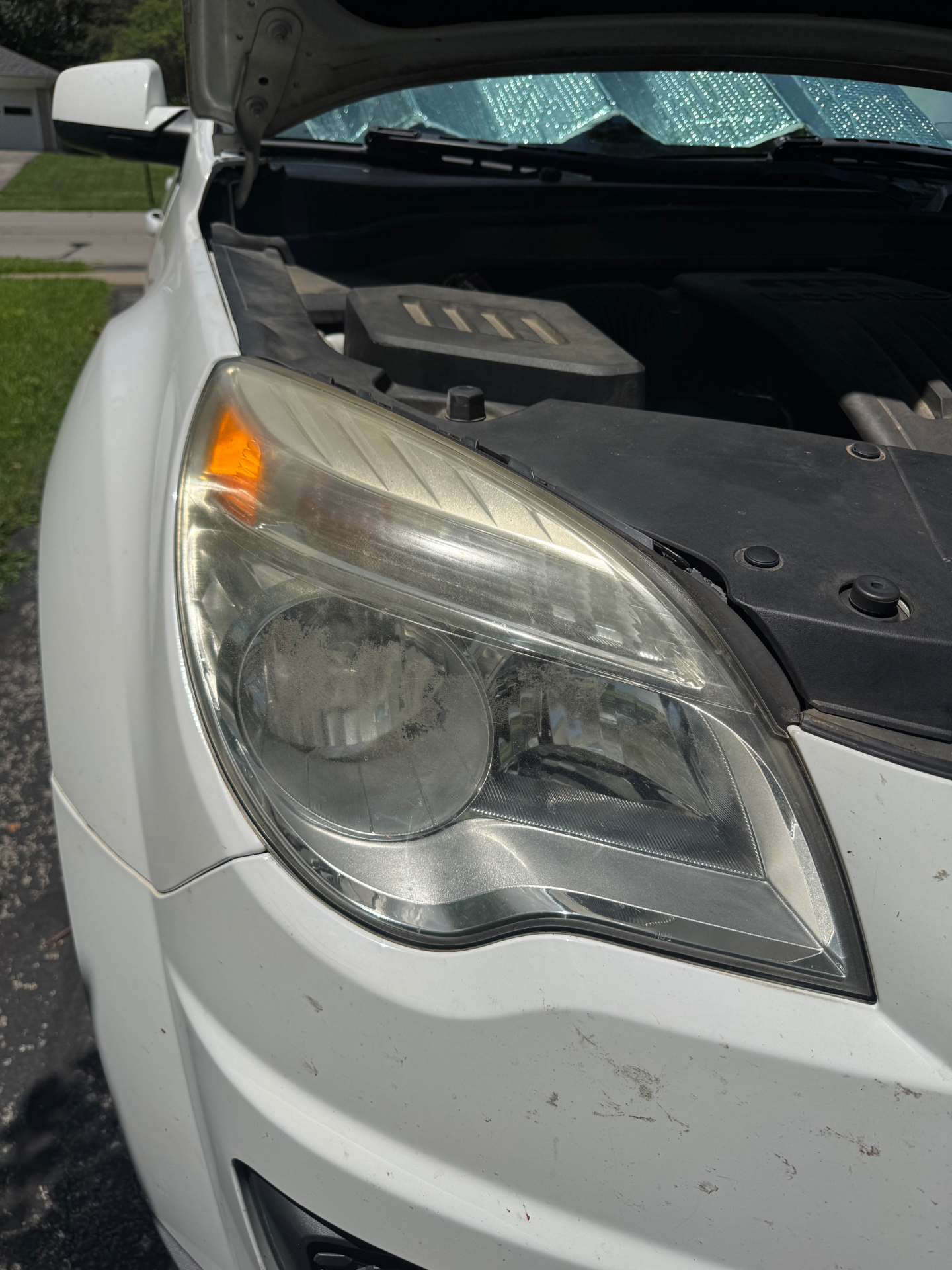 Foggy Chevy Equinox passenger headlight before restoration