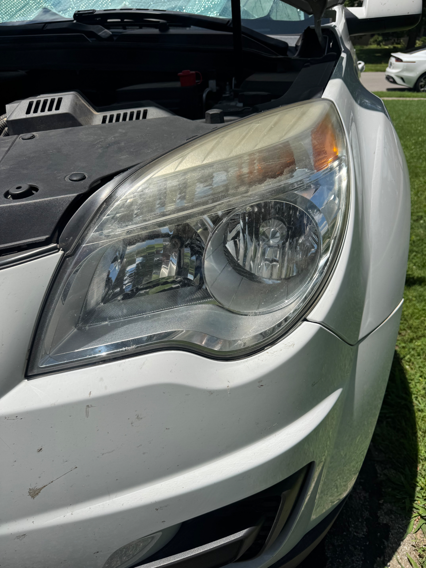 Oxidized Chevy Equinox driver headlight before restoration