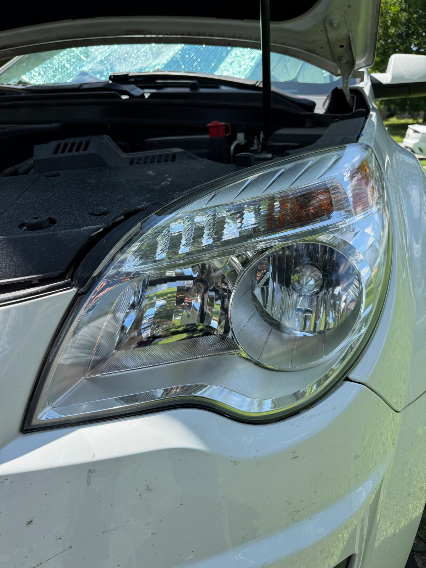 Restored Chevy Equinox passenger headlight after UV clear coat